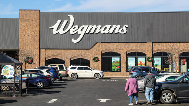 A couple is seen at the parking lot of a Wegmans supermarket 